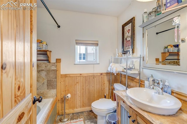 414 Griffin Ave, Canon City, CO 81212 - bathroom with wainscoting, a tub to relax in, vanity, and wood walls
