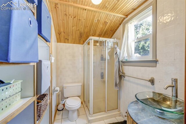 414 Griffin Ave, Canon City, CO 81212 - bathroom featuring tile walls, wooden ceiling, tile patterned flooring, a shower stall, and vanity