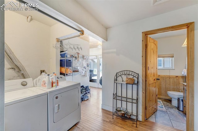 414 Griffin Ave, Canon City, CO 81212 - laundry area featuring washing machine and dryer, light wood finished floors, wainscoting, and wooden walls