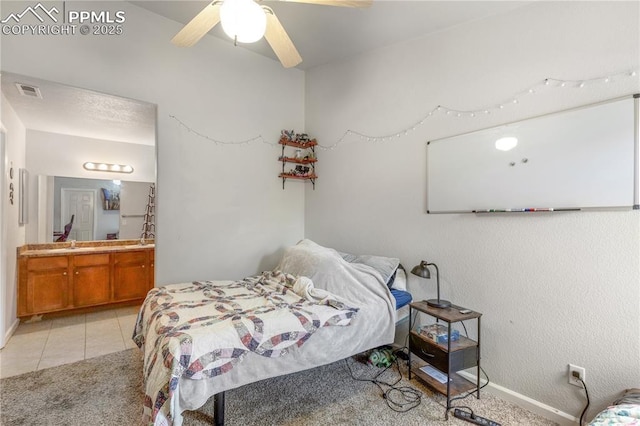 7104 Ash Creek Hts Unit 203, Colorado Springs, CO 80922 - bedroom with light carpet, ensuite bathroom, light tile patterned floors, and a ceiling fan