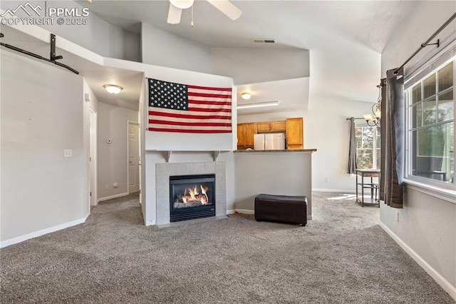 7104 Ash Creek Hts Unit 203, Colorado Springs, CO 80922 - carpeted living area featuring ceiling fan and a tiled fireplace