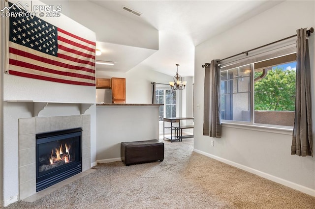 7104 Ash Creek Hts Unit 203, Colorado Springs, CO 80922 - living area with a chandelier, carpet flooring, a fireplace, and lofted ceiling
