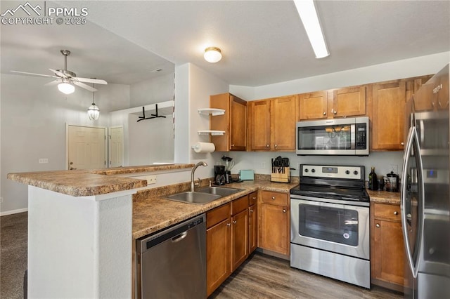 7104 Ash Creek Hts Unit 203, Colorado Springs, CO 80922 - kitchen featuring stainless steel appliances, a peninsula, brown cabinets, open shelves, and a ceiling fan