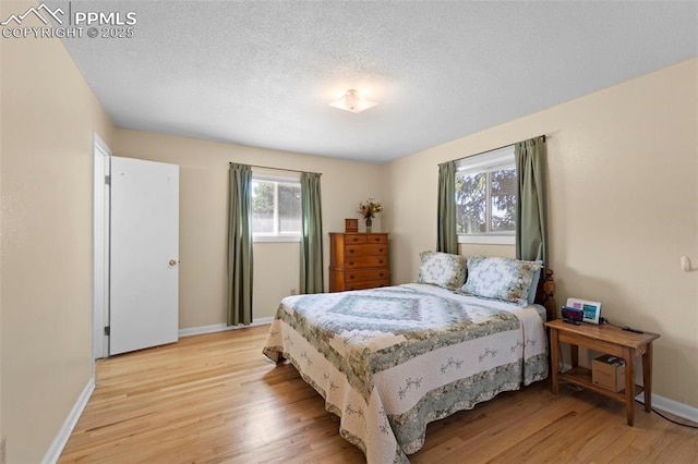 811 N Baldwin St, Woodland Park, CO 80863 - bedroom with light wood-style floors and a textured ceiling
