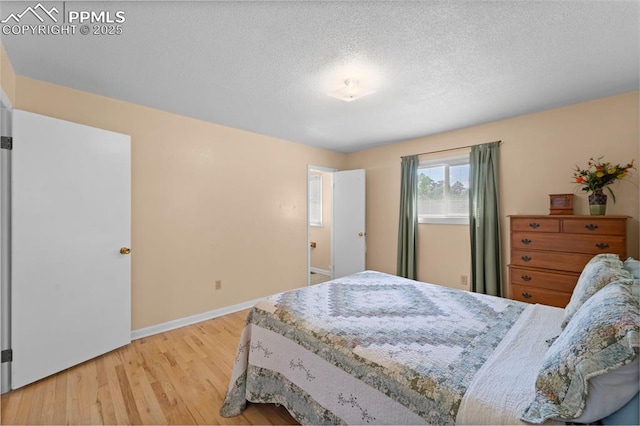 811 N Baldwin St, Woodland Park, CO 80863 - bedroom featuring light wood-style flooring and a textured ceiling