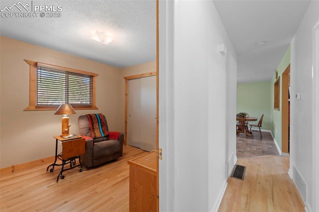 811 N Baldwin St, Woodland Park, CO 80863 - hallway with light wood-style floors and a textured ceiling
