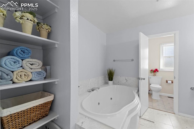 811 N Baldwin St, Woodland Park, CO 80863 - bathroom with toilet and a whirlpool tub