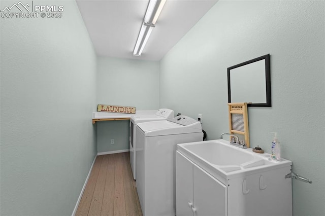 811 N Baldwin St, Woodland Park, CO 80863 - laundry room with independent washer and dryer, light wood finished floors, and cabinet space