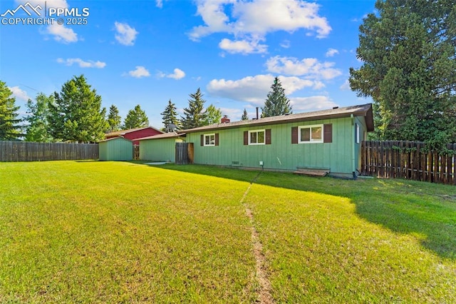 811 N Baldwin St, Woodland Park, CO 80863 - rear view of house featuring a shed, a fenced backyard, and board and batten siding