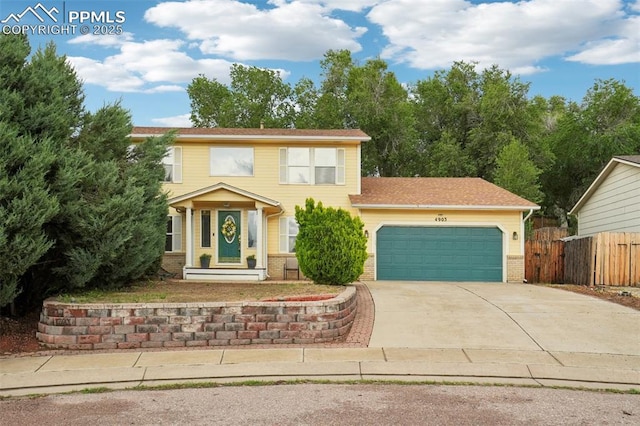 4903 Wainwright Dr, Colorado Springs, CO 80911 - view of front facade featuring an attached garage, concrete driveway, and brick siding