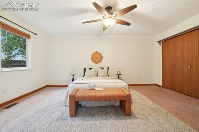 4903 Wainwright Dr, Colorado Springs, CO 80911 - carpeted bedroom with a ceiling fan, a closet, and a textured ceiling