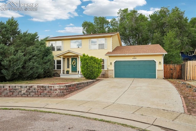 4903 Wainwright Dr, Colorado Springs, CO 80911 - view of front of property with a garage, concrete driveway, and brick siding