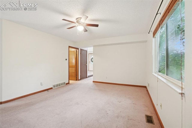 4903 Wainwright Dr, Colorado Springs, CO 80911 - spare room featuring light colored carpet, ceiling fan, and a textured ceiling
