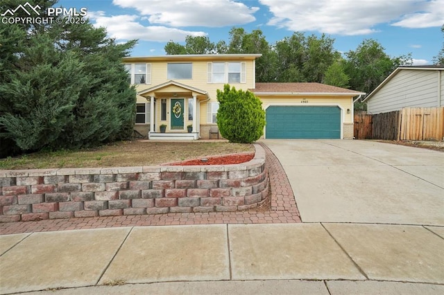 4903 Wainwright Dr, Colorado Springs, CO 80911 - view of front facade featuring driveway, an attached garage, and brick siding