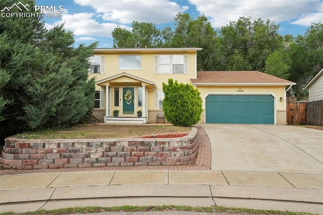 4903 Wainwright Dr, Colorado Springs, CO 80911 - view of front facade with an attached garage, driveway, and brick siding