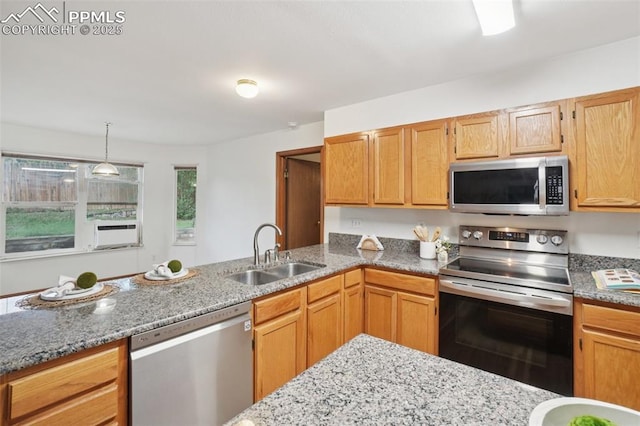 4903 Wainwright Dr, Colorado Springs, CO 80911 - kitchen with appliances with stainless steel finishes, light stone counters, decorative light fixtures, and a peninsula