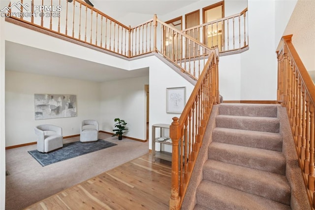 4903 Wainwright Dr, Colorado Springs, CO 80911 - staircase with wood-type flooring and a high ceiling