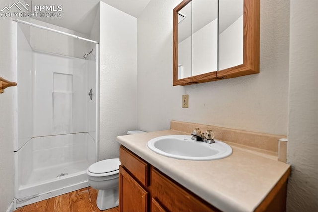 823 N Corona St, Colorado Springs, CO 80903 - bathroom featuring wood finished floors, a shower stall, and vanity