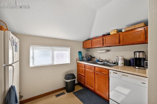 823 N Corona St, Colorado Springs, CO 80903 - kitchen with white appliances, light countertops, brown cabinetry, and vaulted ceiling