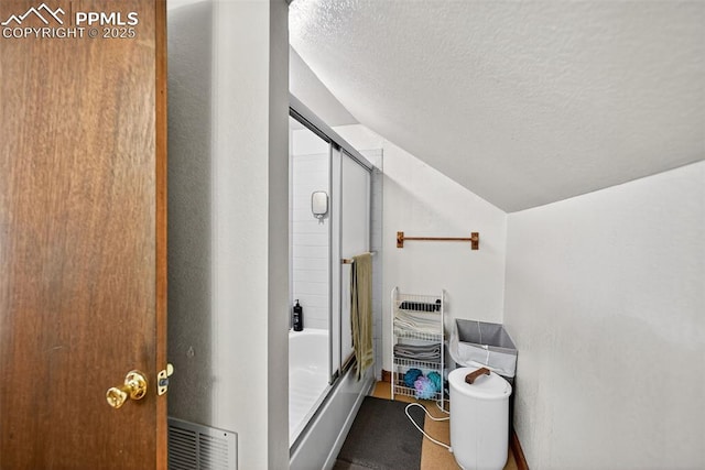 823 N Corona St, Colorado Springs, CO 80903 - bathroom with lofted ceiling, enclosed tub / shower combo, and a textured ceiling