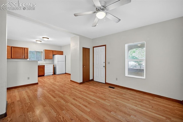 823 N Corona St, Colorado Springs, CO 80903 - unfurnished living room with light wood-style flooring, plenty of natural light, and a ceiling fan