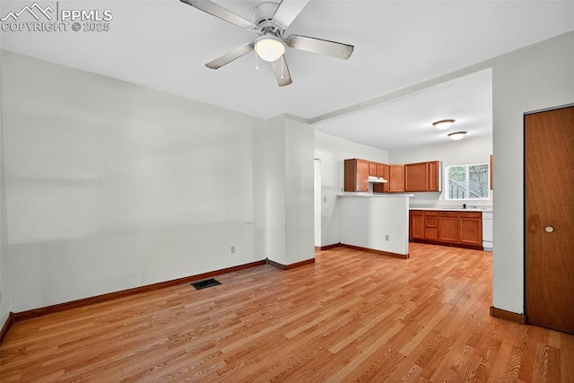 823 N Corona St, Colorado Springs, CO 80903 - unfurnished living room with light wood-style flooring and ceiling fan