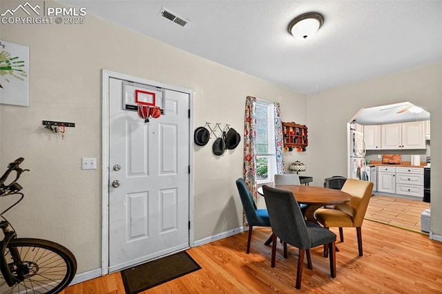 823 N Corona St, Colorado Springs, CO 80903 - dining room featuring light wood finished floors and arched walkways