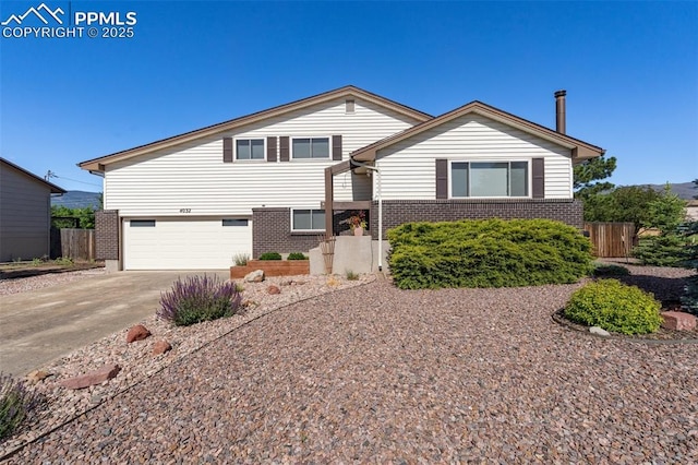 4032 E Darby Cir, Colorado Springs, CO 80907 - view of front of house with brick siding, driveway, and an attached garage