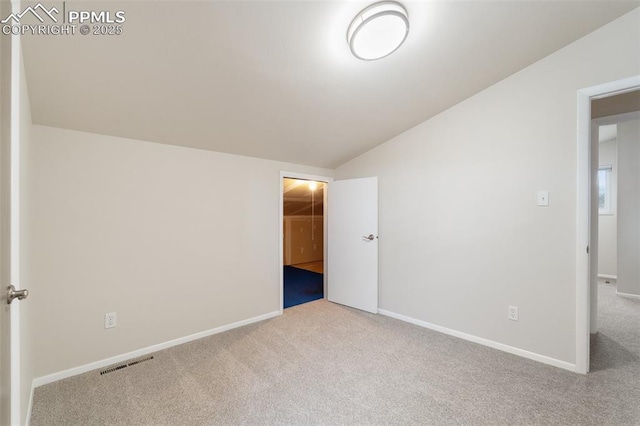 4032 E Darby Cir, Colorado Springs, CO 80907 - unfurnished bedroom with carpet, lofted ceiling, and a walk in closet