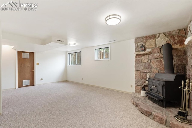 4032 E Darby Cir, Colorado Springs, CO 80907 - unfurnished living room with carpet floors and a wood stove