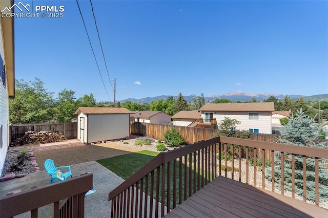 4032 E Darby Cir, Colorado Springs, CO 80907 - deck featuring a mountain view, a fenced backyard, a shed, and a patio area