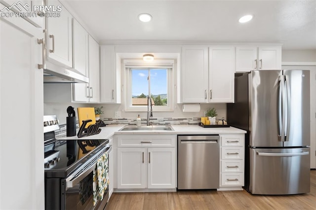 4032 E Darby Cir, Colorado Springs, CO 80907 - kitchen featuring stainless steel appliances, under cabinet range hood, light countertops, white cabinetry, and recessed lighting