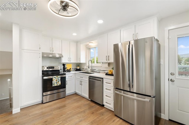 4032 E Darby Cir, Colorado Springs, CO 80907 - kitchen with appliances with stainless steel finishes, under cabinet range hood, white cabinetry, light wood-style floors, and recessed lighting