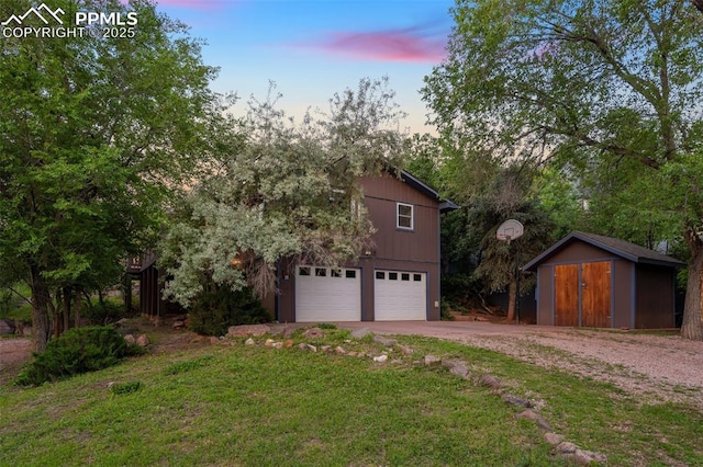 22 Puma Path, Manitou Springs, CO 80829 - view of side of property featuring driveway, a storage shed, and an attached garage