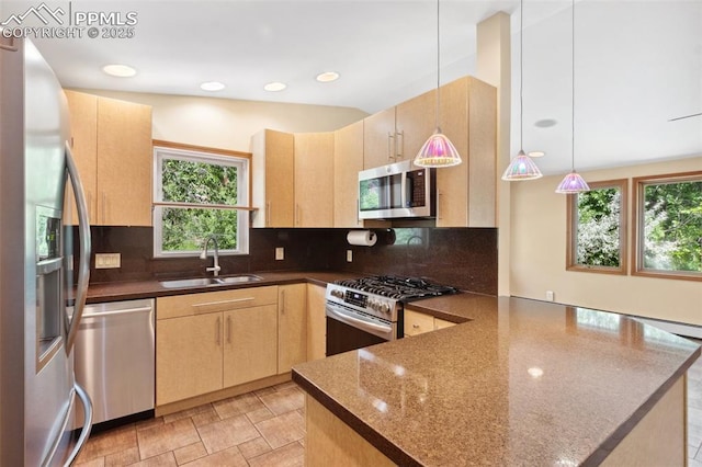 22 Puma Path, Manitou Springs, CO 80829 - kitchen with appliances with stainless steel finishes, light brown cabinets, a peninsula, plenty of natural light, and recessed lighting