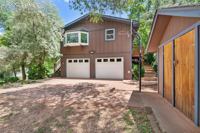 22 Puma Path, Manitou Springs, CO 80829 - chalet / cabin with stairs, a garage, and concrete driveway
