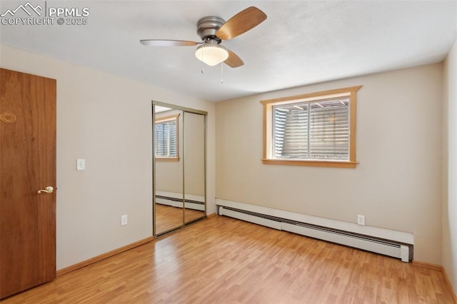 22 Puma Path, Manitou Springs, CO 80829 - unfurnished bedroom with baseboard heating, wood finished floors, a ceiling fan, and a closet