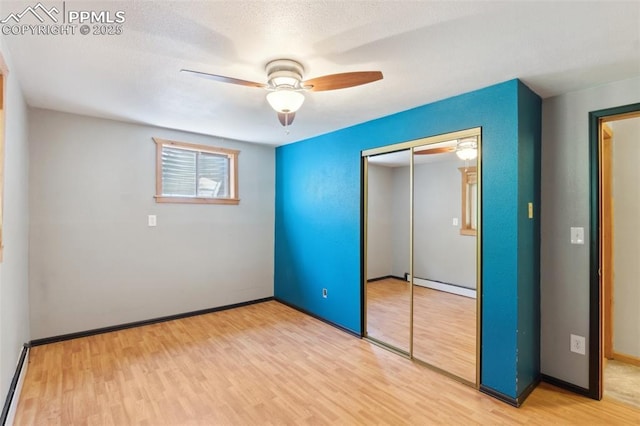 22 Puma Path, Manitou Springs, CO 80829 - unfurnished bedroom featuring light wood finished floors, a closet, and a ceiling fan