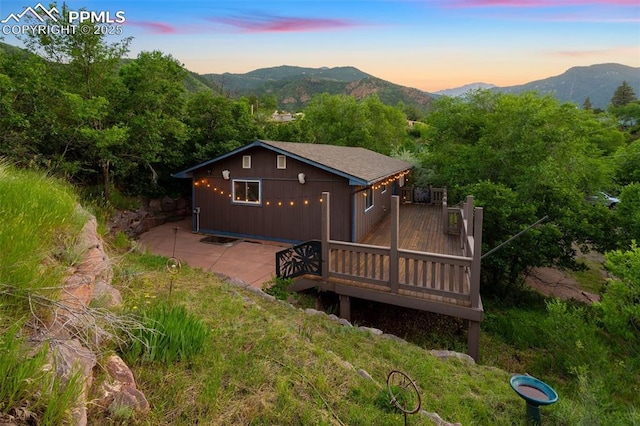 22 Puma Path, Manitou Springs, CO 80829 - rear view of house with a deck with mountain view and a patio