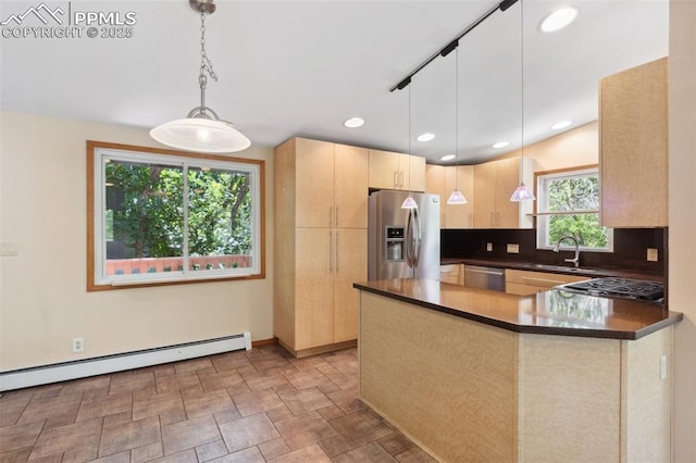 22 Puma Path, Manitou Springs, CO 80829 - kitchen with stainless steel appliances, light brown cabinets, a baseboard radiator, dark countertops, and a peninsula
