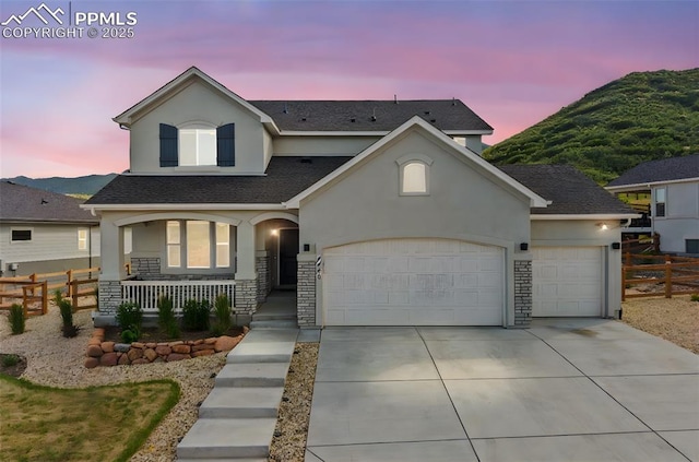 5446 Mesa Top Dr, Monument, CO 80132 - traditional-style house featuring stucco siding, covered porch, concrete driveway, and an attached garage