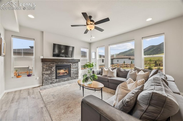 5446 Mesa Top Dr, Monument, CO 80132 - living area featuring plenty of natural light, wood finished floors, a ceiling fan, a fireplace, and recessed lighting