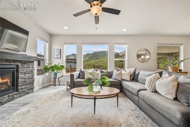 5446 Mesa Top Dr, Monument, CO 80132 - living room with wood finished floors, a stone fireplace, ceiling fan, and recessed lighting