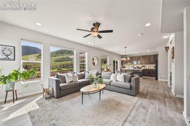 5446 Mesa Top Dr, Monument, CO 80132 - living room with a ceiling fan, recessed lighting, light wood-style flooring, and a mountain view