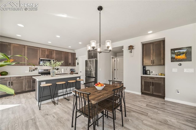 5446 Mesa Top Dr, Monument, CO 80132 - dining space with light wood-style flooring, a chandelier, and recessed lighting