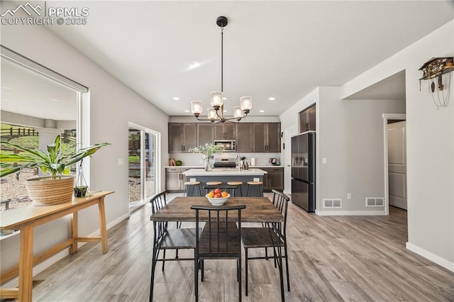 5446 Mesa Top Dr, Monument, CO 80132 - dining space with light wood finished floors, a chandelier, and recessed lighting