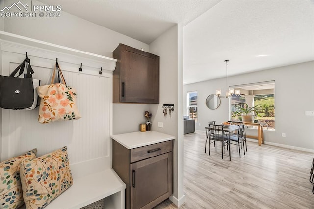 5446 Mesa Top Dr, Monument, CO 80132 - mudroom featuring light wood-style floors and a chandelier