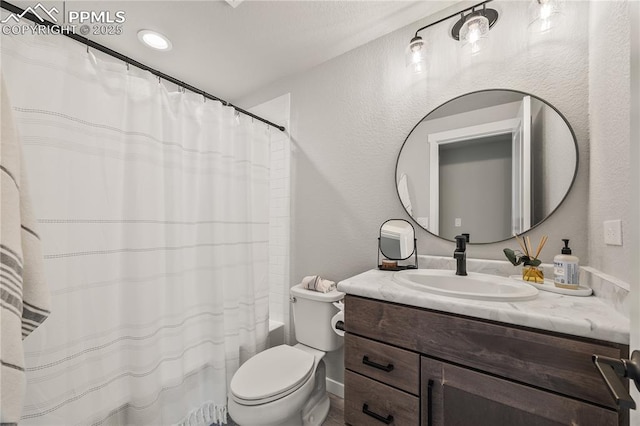 5446 Mesa Top Dr, Monument, CO 80132 - bathroom featuring vanity, a textured wall, and shower / bath combination with curtain