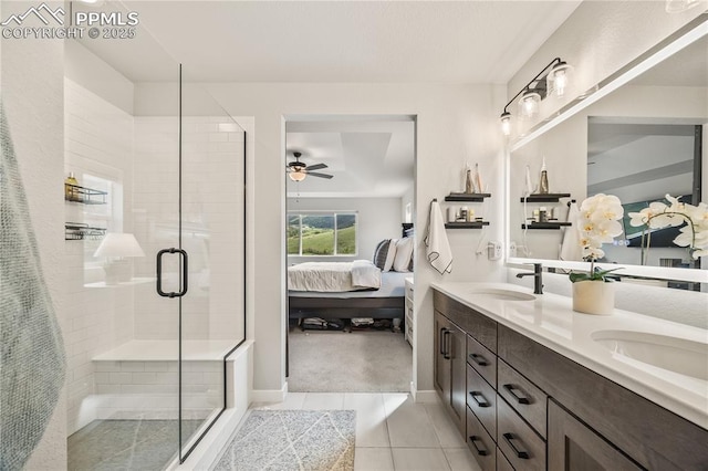 5446 Mesa Top Dr, Monument, CO 80132 - ensuite bathroom with ceiling fan, double vanity, tile patterned flooring, and a stall shower