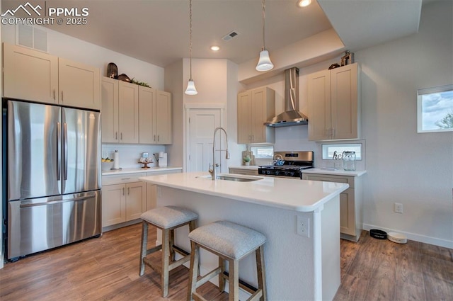 2186 Keara Hts, Colorado Springs, CO 80919 - kitchen featuring stainless steel appliances, wall chimney range hood, wood finished floors, light countertops, and recessed lighting